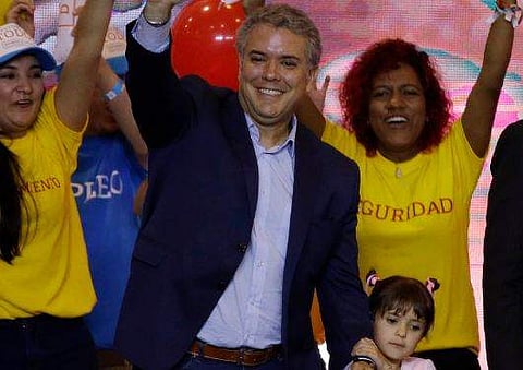 Ivan Duque, presidential candidate for the Democratic Center, waves to supporters after winning the first round presidential election in Bogota, Colombia, Sunday, May 27, 2018. (AP)