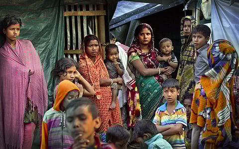 Refugees stand outside their make shift shelters at Kutupalong refugee camp near Cox's bazar, Bangladesh. | AP