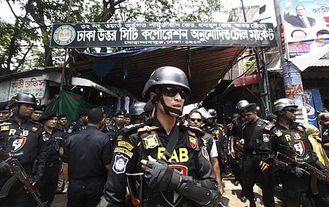 Bangladesh's Rapid Action Battalion (RAB) soldiers stand guard during a raid on suspected drug dealers at Mohammadpur Geneva Camp in Dhaka, Bangladesh, Saturday, May 26, 2018. | AP