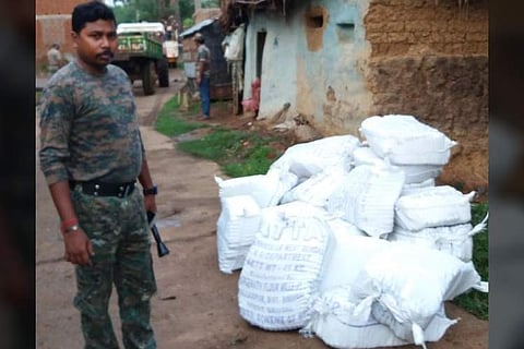 A policeman with the sacks of ammonium nitrate at Bahadurpur village under Nalhati in Birbhum district of West Bengal on Tuesday. | EPS