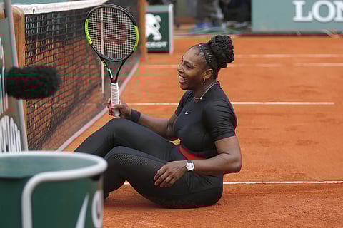 Serena Williams laughs after slipping on the court during her first round match of the French Open tennis tournament against Krystina Pliskova | AP