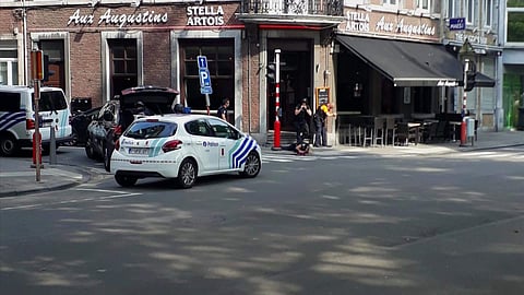 In this frame grab taken from video, police at the scene near the body of a police officer on the ground after a shooting incident, in Liege, Belgium, Tuesday, May 29, 2018. | Associated Press