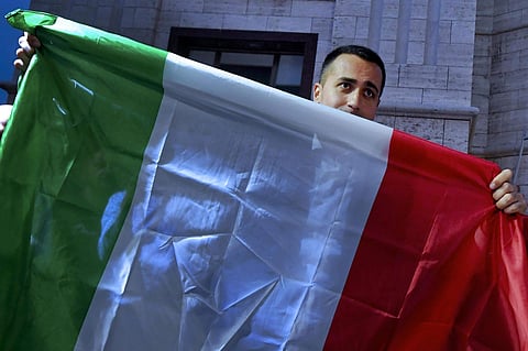 Five-Stars Movement (M5S) leader Luigi Di Maio holds an Italian flag during a rally in Naples, Italy, Tuesday, May 29, 2018. (AP)