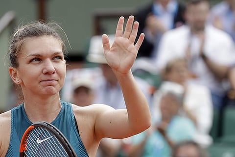 Romania's Simona Halep celebrates after defeating Alison Riske of the U.S. during their first round match of the French Open tennis tournament at the Roland Garros stadium, Wednesday, May 30, 2018 in Paris. Halep won 2-6, 6-1, 6-1. | AP