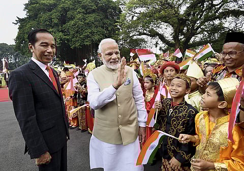 Prime Minister Narendra Modi interacts with children who greeted him during his ceremonial welcome at Istana Merdeka. | PTI