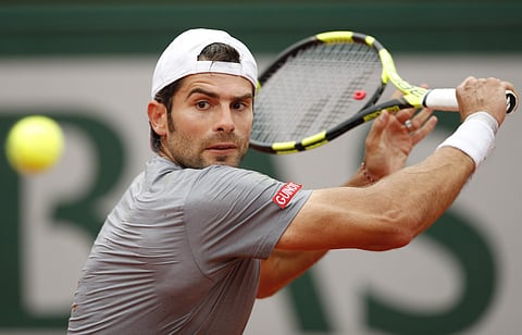Simone Bolelli returns a shot against Rafael Nadal during their first round match of the French Open tournament at the Roland Garros stadium in Paris. | AP