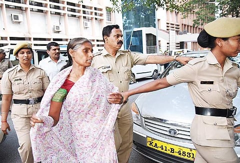 The woman identified as Sonia Rani, who was caught with a knife at the Lokayukta office, being led away by police personnel on Thursday | Nagaraja Gadekal