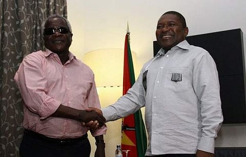 File: Mozambique’s President Filipe Nyusi (R) shakes hands with opposition leader Afonso Dhlakama (L) on February 7, 2015 in Maputo, Mozambique. | AFP