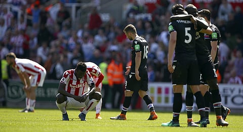Stoke City's Mame Biram Diouf, second left gestures after Stoke City are relegated following the English Premier League soccer match between Stoke City and Crystal Palace, at the bet365 Stadium, in Stoke, England, Saturday May 5, 2018. | AP