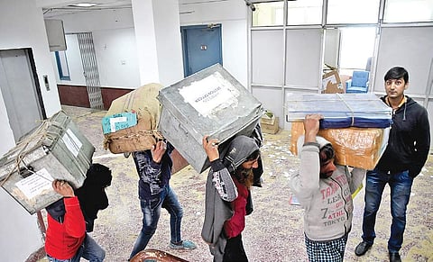 Porters taking boxes of files to the offices in Srinagar