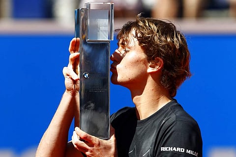 Germany's Alexander Zverev kisses the trophy after winning his final match against Philipp Kohlschreiber of Germany at the ATP tennis tournament in Munich. (AP)