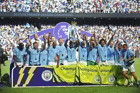 Manchester City players lift the English Premier League trophy after the match between Manchester City and Huddersfield Town at Etihad stadium in Manchester, England. (AP)