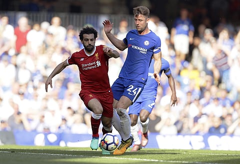 Liverpool's Mohamed Salah, left, challenges for the ball with Chelsea's Gary Cahill during the English Premier League soccer match between Chelsea and Liverpool at Stamford Bridge stadium in London, Sunday, May 6, 2018. | AP