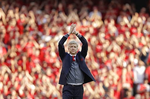 Arsenal's French manager Arsene Wenger applauds before his lap of honor at the Emirates Stadium in London. (AP)