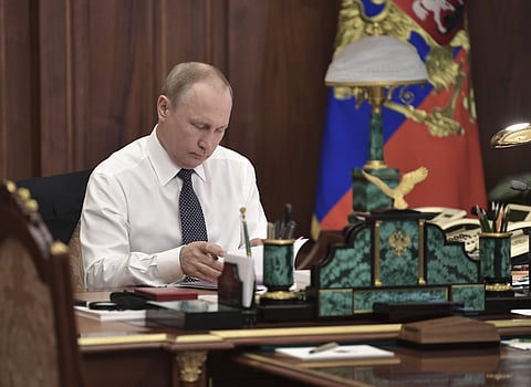 Vladimir Putin sits in his Kremlin cabinet prior his inauguration ceremony as new Russia's president in Moscow. | AP
