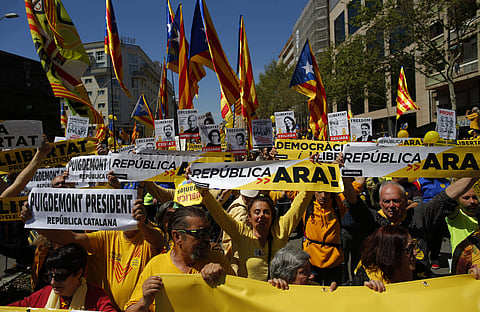 Demonstrators wave esteladas or independence flags in Barcelona, Spain, Sunday, April 15, 2018. (AP Photo)