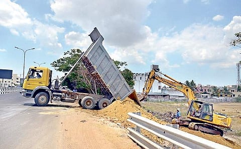 A tractor of AST construction dumping lake soil for levelling the  Pallavaram-Thoraipakkam link road | Martin Louis
