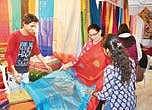Customers look at sarees displayed at the exhibition in Marine Drive, Kochi