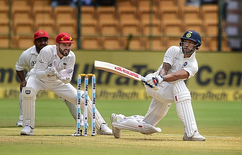 Shikhar Dhawan plays a shot on the first day of the one-off Test match against Afghanistan at Chinnaswamy Stadium in Bengaluru on Thursday June 14 2018. | PTI