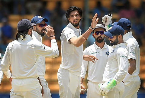 Indian cricketer Ishant Sharma with teammates celebrates the wicket of Afghanistan batsman Javed Ahmadi during the second day of a one-off test match at M Chinnaswamy Stadium in Bengaluru on Friday, June 15, 2018. (PTI)