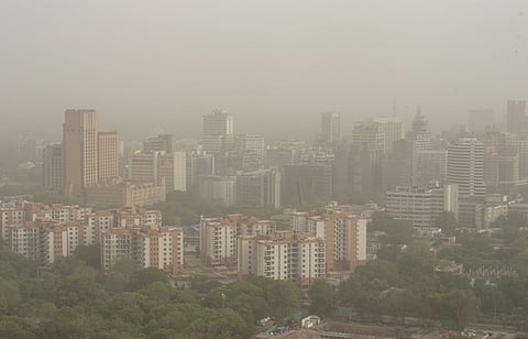 A thick blanket of dust and haze envelops the city skyline in New Delhi. (PTI)