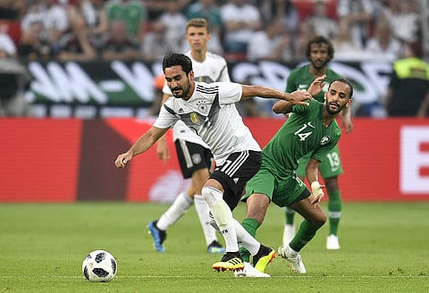 Germany's Ilkay Gundogan, left, duels for the ball with Saudi Arabia's Abdullah Otayf during a friendly soccer match between Germany and Saudi Arabia at BayArena in Leverkusen, Germany, Friday, June 8, 2018. | AP