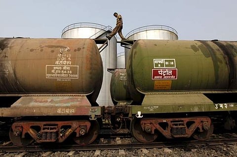 A worker walks atop a tanker wagon to check the freight level at an oil terminal on the outskirts of Kolkata, in this November 27, 2013 file photo. (Photo | Reuters)