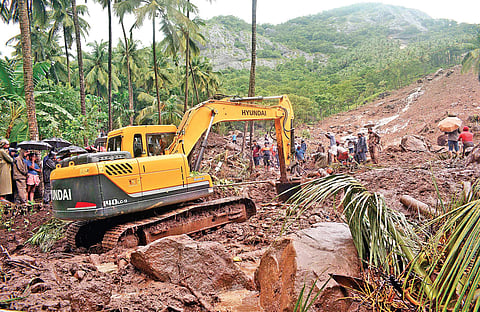 Rescue workers trying to recover bodies trapped underneath the mud at Karinchola in Kozhikode after a landslide  | Manu R Mavelil