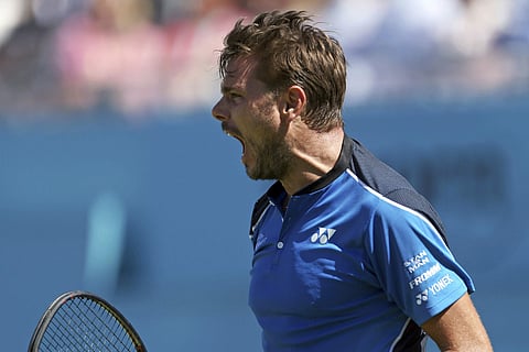 Switzerland's Stan Wawrinka reacts as he plays Britain's Cameron Norrie on day one of the Queen's Club Championship at the Queens Club, in London. (AP)