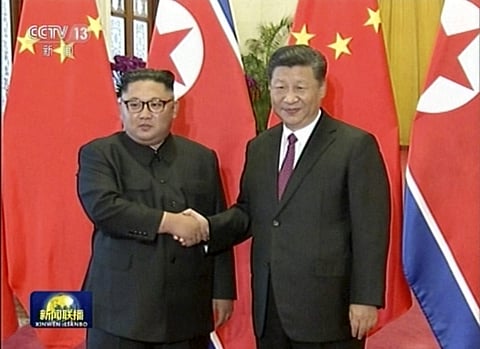 In this image taken from video footage run by China's CCTV on June 19, 2018, via AP Video, Chinese President Xi Jinping shakes hands with North Korean leader Kim Jong Un during a welcome ceremony at the Great Hall of the People in Beijing. | AP