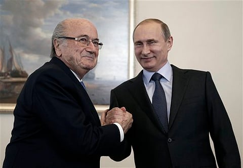 On July 25, 2015, Russian President Vladimir Putin, right, and former FIFA President Sepp Blatter met before the 2018 World Cup preliminary draw in the Konstantin palace in St. Petersburg, Russia. (File photo | AP)