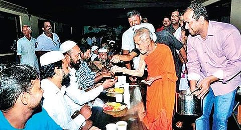 File photo of Pejavar seer serving dates to Muslims at the Iftar event in Udupi last year