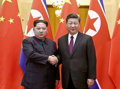 North Korean leader Kim Jong Un, left, and Chinese President Xi Jinping shake hands in Beijing, China. (File | AP)