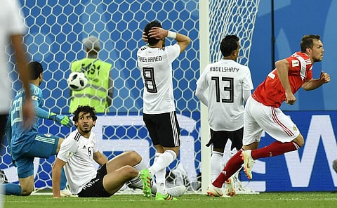 Egypt's defense watches disappointed after Russia's Artyom Dzyuba, right, scored his side's third goal during the group A match between Russia and Egypt at the 2018 soccer World Cup in the St. Petersburg stadium in St. Petersburg, Russia, Tuesday, June 19