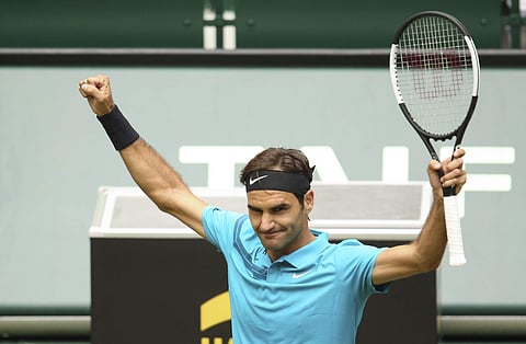 Switzerland Roger Federer waves after winning against France's Benoit Paire in their round of 16 match at the ATP tennis tournament in Halle. (AP)