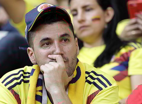 A Colombian fan reacts after his team's 2-1 loss to Japan at the 2018 soccer World Cup in the Mordavia Arena in Saransk, Russia, Tuesday, June 19, 2018. | AP