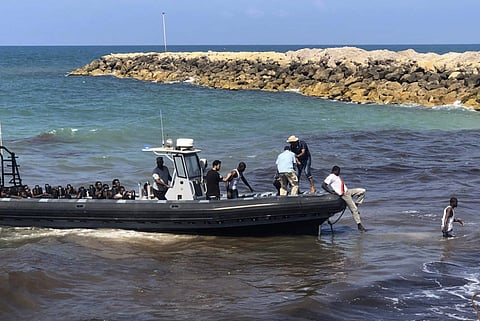 In this Wednesday, June 20, 2018 photo, released by the Libyan coast guard, African migrants who were found on a damaged rubber boat in the Mediterranean Sea and rescued by the Libyan coast guard arrive to shore, east of the capital, Tripoli, Libya. | AP