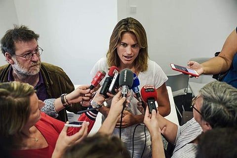 French former world number one Amelie Mauresmo speaks to journalists following a press conference after she became the first woman appointed to captain France's Davis Cup team by the French tennis federation. | AFP