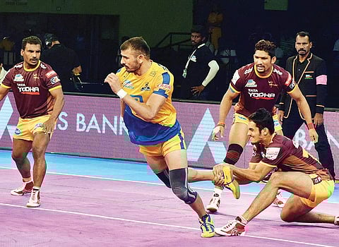 Tamil Thalaiva’s Ajay Thakur (centre) in action against UP Yoddha. | Express File Photo