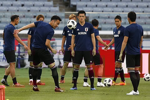 Japan's Maya Yoshida heads the ball during a training session. | AP