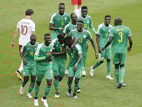 Senegal's players celebrate their opening goal with Senegal's Sadio Mane during the group H match between Poland and Senegal at the 2018 soccer World Cup in the Spartak Stadium in Moscow. | AP