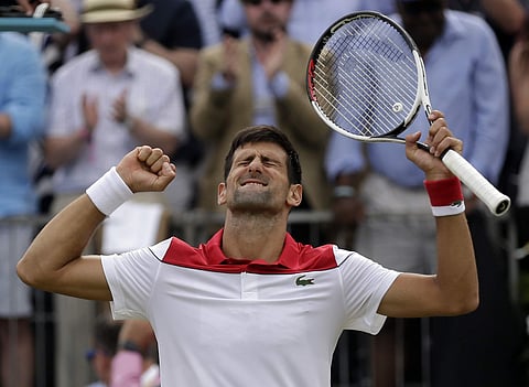 Serbia's Novak Djokovic celebrates after beating France's Jeremy Chardy in their semifinal tennis match at the Queen's Club tennis tournament in London. (AP)