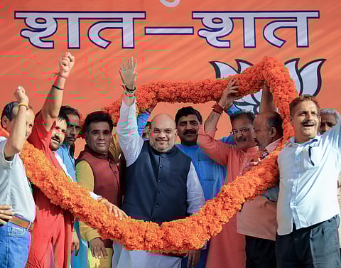 BJP National President Amit Shah being garlanded by the party leaders during a public rally on the death anniversary of party founder Syama Prasad Mukherjee in Jammu on Saturday June 23 2018. | PTI