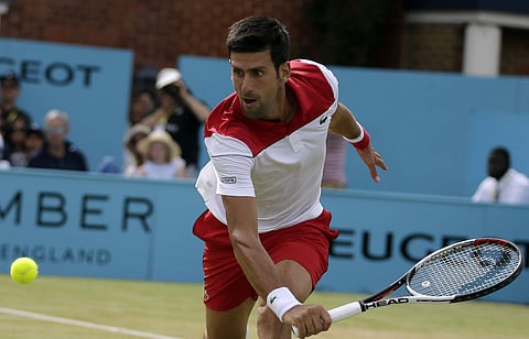 Serbia's Novak Djokovic returns to France's Jeremy Chardy during their semifinal tennis match at the Queen's Club tennis tournament in London, Saturday, June 23, 2018. | AP