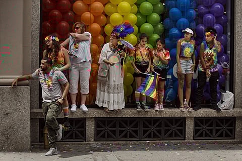 People watch as revelers march during the New York City Pride Parade on Sunday, June 24, 2018, in New York. (AP Photo/Andres Kudacki)