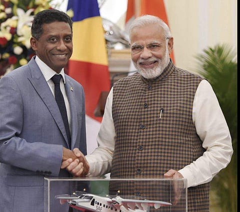 Prime Minister Narendra Modi pose for a photo with model of Dornier aircraft which will be gifted to Seychelles President Danny Antoine Rollen Faure after their meeting at Hyderabad House in New Delhi on Monday June 25 2018. | PTI
