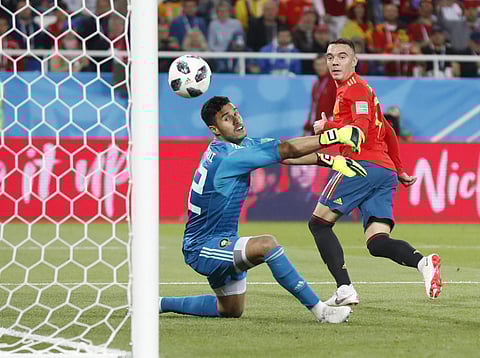 Spain's Iago Aspas, right, scores his side's second goal past Morocco goalkeeper Monir El Kajoui, during the group B match between Spain and Morocco at the 2018 soccer World Cup at the Kaliningrad Stadium in Kaliningrad. | AP