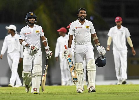 Kusal Mendis (L) and Dilruwan Perera (R) of Sri Lanka walk off the field at the end of day 3 of the 3rd Test between West Indies and Sri Lanka at Bridgetown, Barbados. (Photo | AFP)