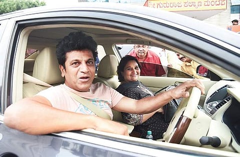 Kannada actor Shivarajkumar and his wife Geetha arrive to vote for Karnataka Film Chamber of Commerce president on Tuesday | nagaraj gadekal