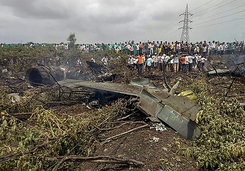 People gather near the debris of a Su-30 MKI fighter jet after it crashed at Wavi-Tushi village near Nashik on Wednesday June 27 2018. ( Photo | PTI)
